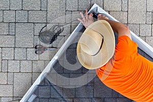 Man replacing damaged wire mesh on a screen door