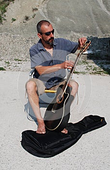 Man Replacing Guitar Strings