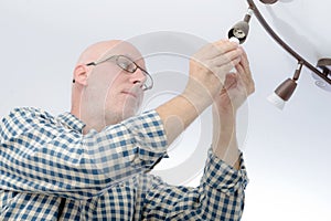 Man replacing the light bulb at home