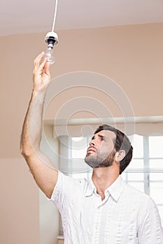 Man replacing the light bulb photo