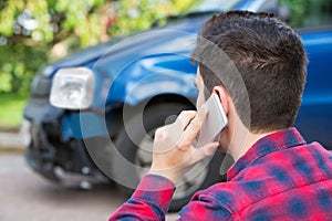Man Reporting Car Crash On Mobile Phone