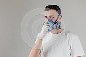 A man in a respirator mask with an increased degree of protection against harmful environmental factor, chemicals or