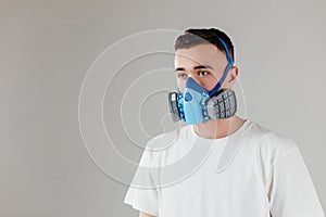 A man in a respirator mask with an increased degree of protection against harmful environmental factor, chemicals or