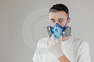 A man in a respirator mask with an increased degree of protection against harmful environmental factor, chemicals or