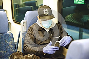 Man with respiratory mask traveling in the public transport by train.Coronavirus, covid 2019