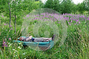 Homeless sleep in nature filed meadow