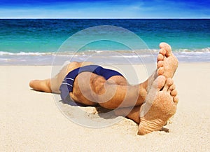 Man resting on the beach.