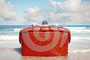 Man resting in couch on the beach