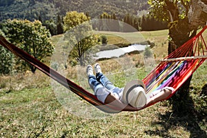 Man resting in hammock outdoors on sunny day