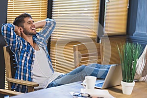 Man resting with his feet up on a table