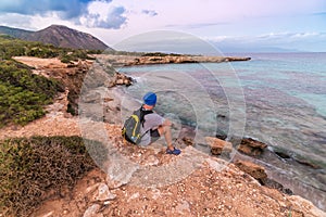 A man resting on a rock