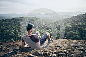 Man resting on rock over jungle