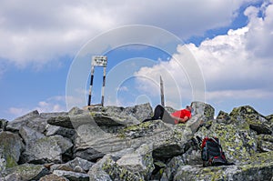 Man resting on top of a mountain