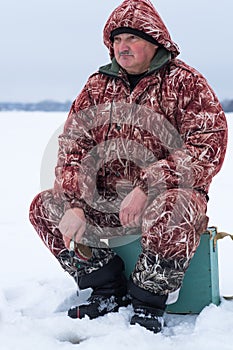 Man resting on winter fishing