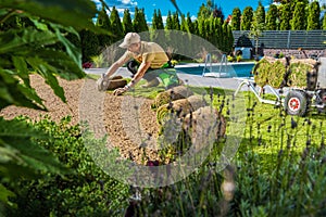 Man Restoring Backyard Garden Grass Turfs