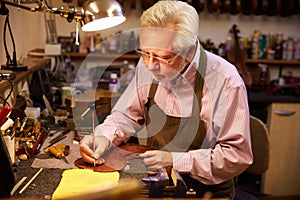 Man Restoring Violin In Workshop