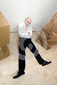 Man rests near stack of boxes