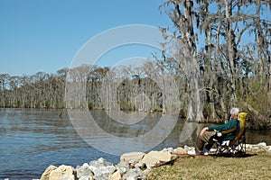 Man rests by a river in Fairview-Riverside State Park