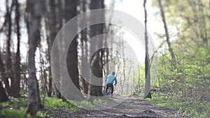 Man on retro bike rides in the woods