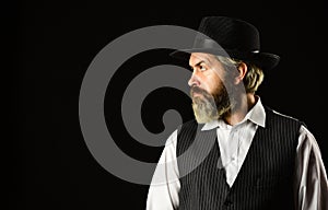 Man with retro Hat. brutal bearded hipster in suit vest. mafia gentlemen club. mature cowboy. detective acknowledgement photo