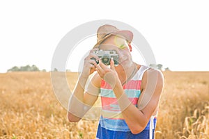 Man with retro photo camera Fashion Travel Lifestyle outdoor