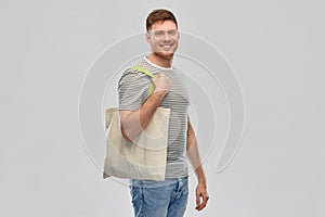 Man with reusable canvas bag for food shopping