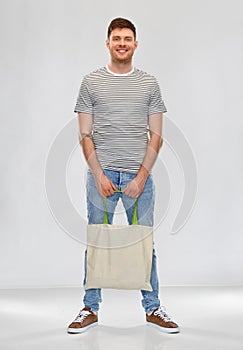 Man with reusable canvas bag for food shopping