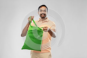 Man with reusable canvas bag for food shopping