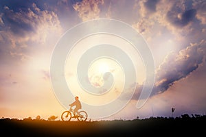 A man Ride on bike on the road with beautiful colorful sky