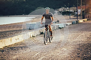 Man ride mountain bike on the beach.