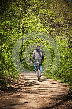 Man ride mountain bike through forest