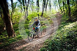 Man ride mountain bike through forest