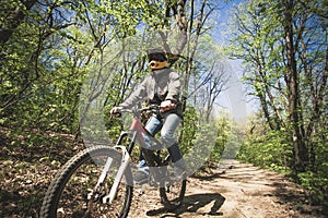 Man ride mountain bike through forest