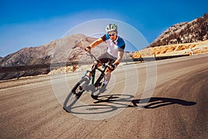 Man ride mountain bike on the road. photo