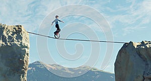 Man ride unicycle on a rope between two mountain cliffs