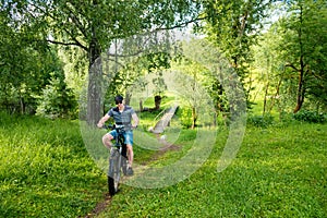 Man rides a bicycle through the countryside. Pleasant sports hobby. Concept of a healthy lifestyle