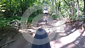 Man rides a bicycle in the woods