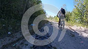 Man rides a bicycle in the woods