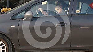 Man rides in car and goes. Man wearing seat belt in car nad going on a journey. Car travel concept