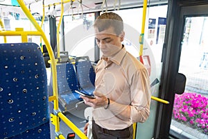 A man rides in an empty bus.