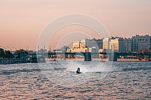 Man rides a jet ski on the Neva River in the center of St. Petersburg