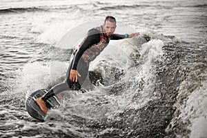 Man rides through the waves on water board