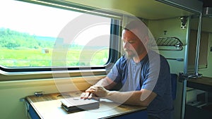 A man rides by the window on a train