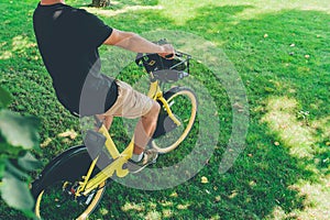 A man rides a yellow rented bike