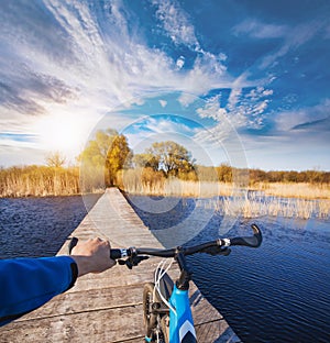 Man riding on a bicycle across the bridge