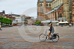 Man riding bicycle in city square