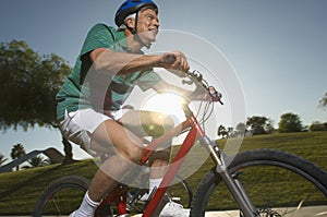 Man Riding Bicycle In Park