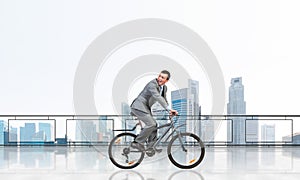 Man riding bicycle on penthouse balcony