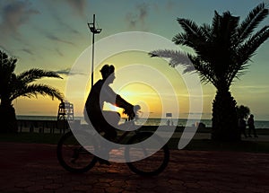 Man riding bicycle sunset ,seafront Batumi, Georgia