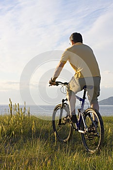 Man riding bicycyle at the sea